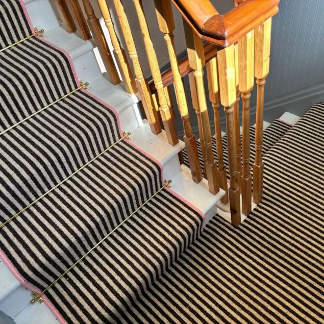 Lerwick in black cream stripe with brass stair rods and bubblegum pink whipping