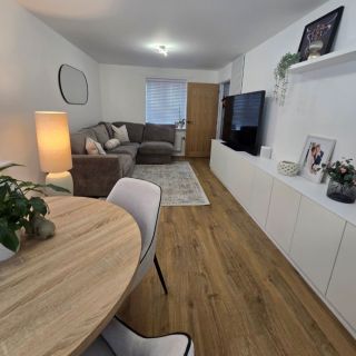 	modern white living room with Quick Step Impressive Classic Natural Oak laminate flooring